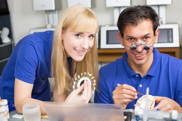 Two dental technicians choosing the right colour for dental porc — Stock Photo, Image