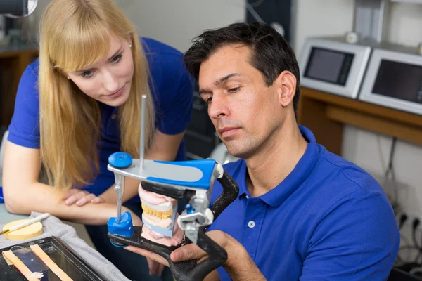 Two dental technicians with articulator — Stock Photo, Image