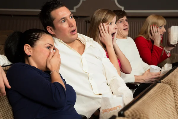 Scared audience members in movie theatre — Stock Photo, Image