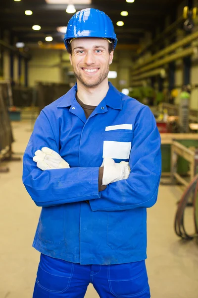 Construction worker in assembly hall — Stock Photo, Image