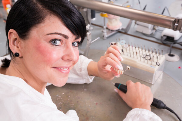 Technician at work in a dental lab or workshop producing a prostheis