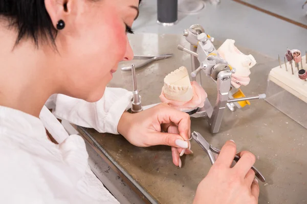 Tecnico che produce una protesi dentale in laboratorio o in officina — Foto Stock