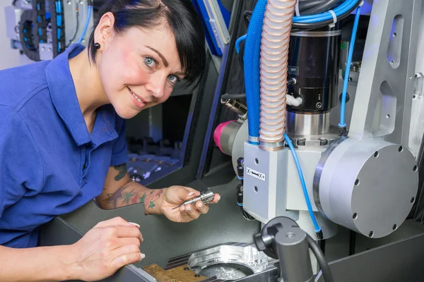 Technician in a dental lab working at a drilling or milling machine — Stock Photo, Image