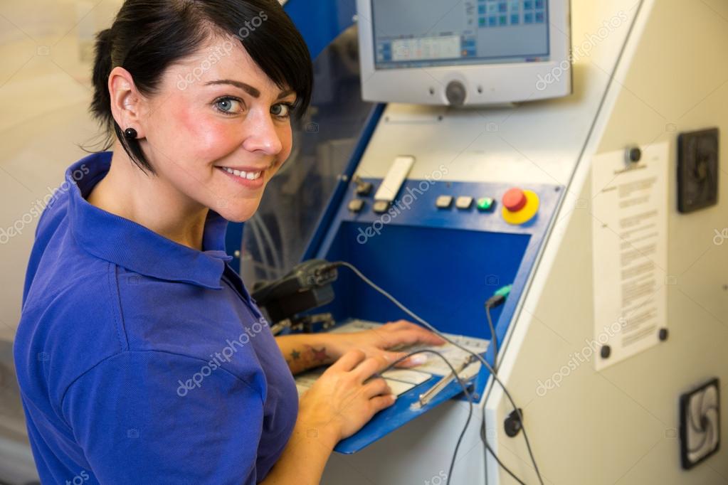 Technician in a dental lab working at a drilling or milling machine
