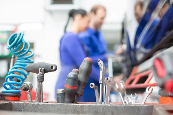 Tools in garage or workshop with mechanics — Stock Photo, Image