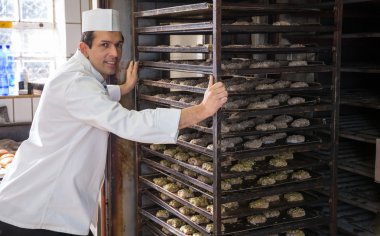bir raf ekmek fırın içine koyarak baker