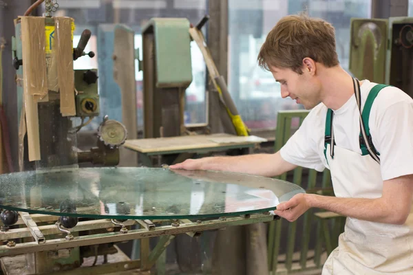 Glazier grinding a pieco of glass — Stock Photo, Image