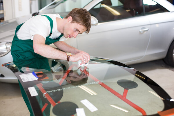 Glazier with car windshield made of glass