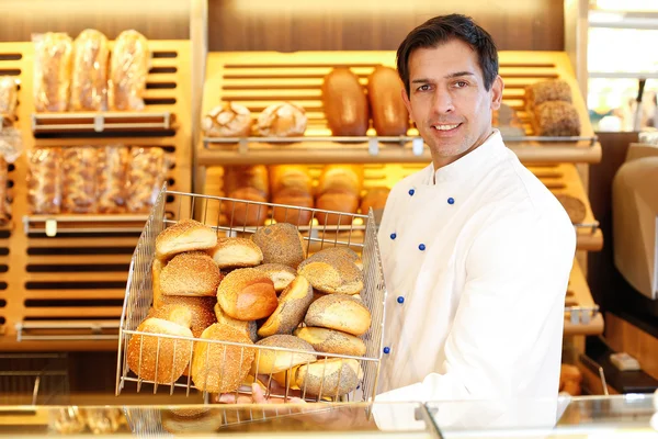 Winkelier met mandje van brood — Stockfoto