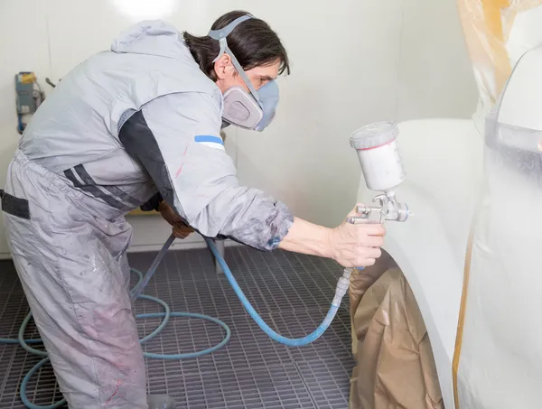 Car body painter spraying paint on bodywork parts — Stock Photo, Image