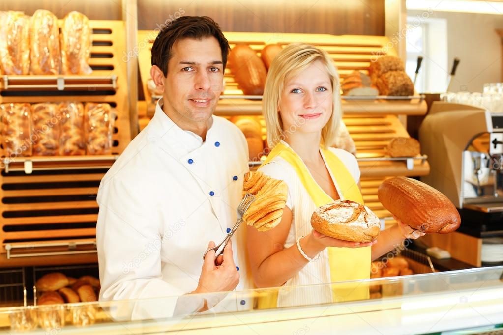 Baker and shopkeeper present pastry