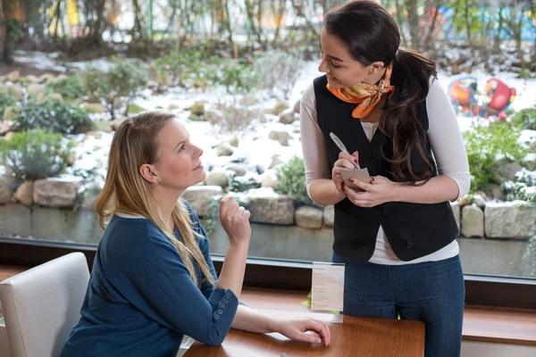 Waitress serving a customer in restaurant or cafe — Stock Photo, Image