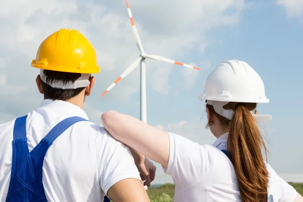 Engineers or installers looking at wind energy turbine — Stock Photo, Image