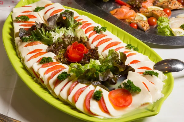 Mozzarella and tomatoes on tray at buffet — Stock Photo, Image