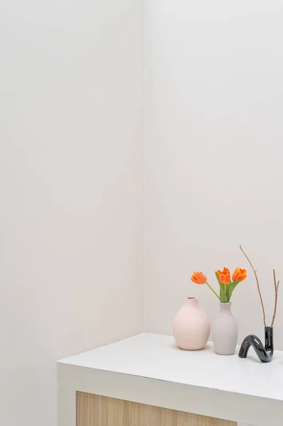 white wall interior with flowers on the table