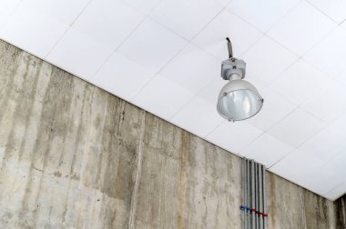Fluorescent lamps on the modern ceiling. Luminous ceiling of square tiles. Interior idea concept.