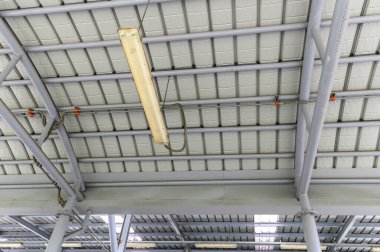 Fluorescent lamps on the modern ceiling. Luminous ceiling of square tiles. Interior idea concept.