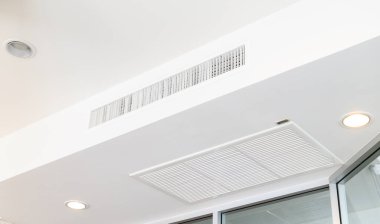 Ceiling mounted cassette type air conditioner. Interior ceiling concept.