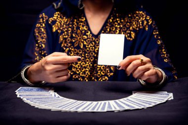 Fortune teller's hands and tarot cards. free copy space on card.