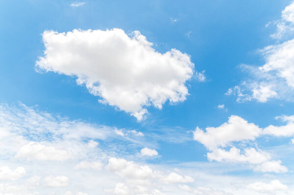 Beautiful white fluffy clouds in blue sky. Nature background from white clouds in sunny day.