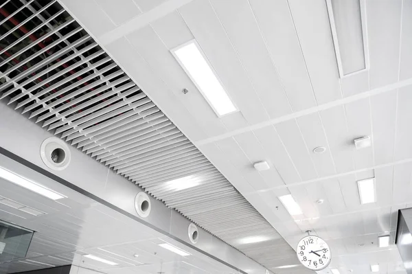 Ceiling mounted cassette type air conditioner and modern lamp light on white ceiling. duct air conditioner for home or office.