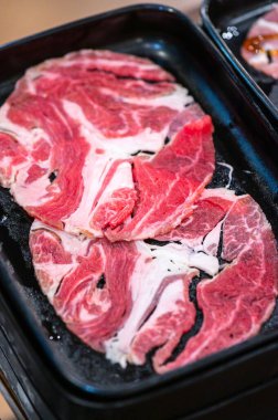 Slide raw beef for Yakiniku. Thin piece beef for Shabu hotpot japanese food style. Close up fresh meat chuck eye for Sukiyaki. top view.