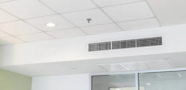 Ceiling mounted cassette type air conditioner and modern lamp light on white ceiling. duct air conditioner for home or office.