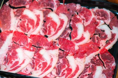 Slide raw beef for Yakiniku. Thin piece beef for Shabu hotpot japanese food style. Close up fresh meat chuck eye for Sukiyaki. top view.