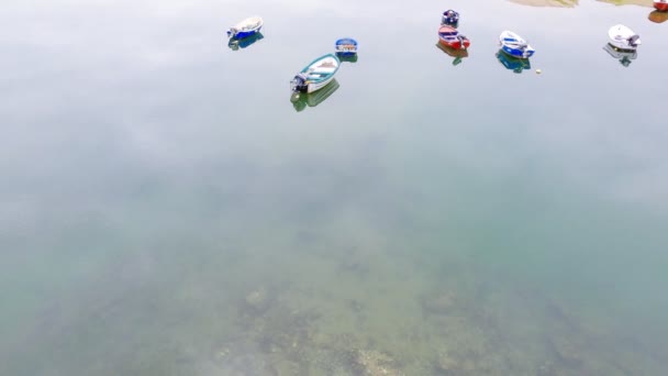 Fishing boats are in a quiet calm bay. Mirror water. Cloudy moody day on the seacoast. Beautiful coastal landscape. Cantabria. Asturias. Camino de Santiago. — Stock Video
