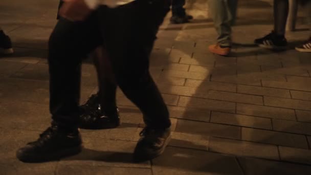 Dancing on city streets. Close-up of feet of dancing couples. People are dancing in the square. Rock and roll, twist, rockabilly. Fun outdoor party. — ストック動画