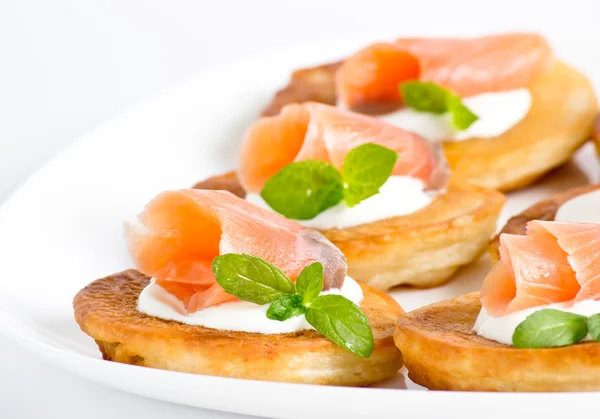 Sliced salted salmon served with pancake — Stock Photo, Image