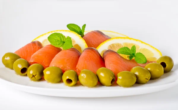 Salmon served with lemon and olive — Stock Photo, Image