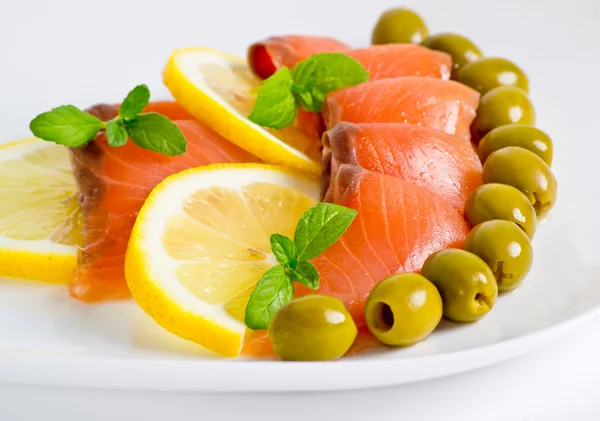 Salmon served with lemon and olive — Stock Photo, Image
