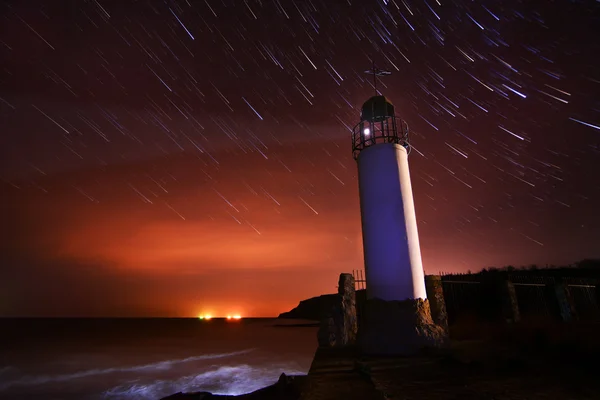 Lighthouse with night sky at background stars trails — Stock Photo, Image
