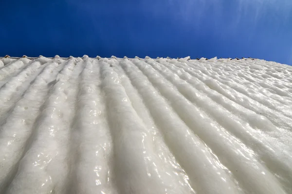 Unusual ice waves texture - on blue sky  background — Stock Photo, Image