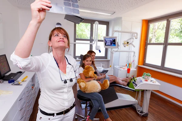 A dentistry doctor looks a x-ray picture in a doctor-surgery Stock Image