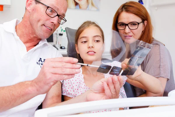 Um médico explica a uma jovem família a imagem do raio-X Fotografias De Stock Royalty-Free