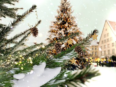 Christmas tree golden stars and confetti decoration pine green branch and pine cone at snowy Tallinn old town marketplace on hall square winter holiday travel to Estonia