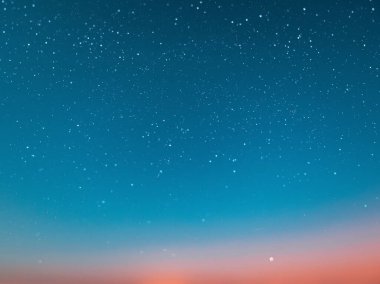 blue bright starry sky on pink yellow sunset at sea water vawe reflection blurred light full moon moonlight  skyline  nebula nature background 