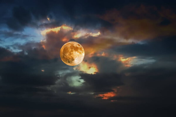Big moon orange yellow dark light dramatic cloudy sky and nature background template