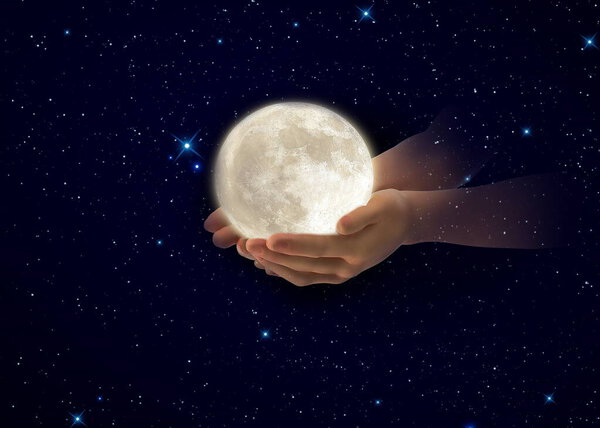 Moon in hands on front blue cloudy sky hold peace world concept natire background