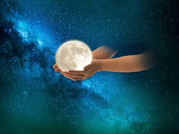 Moon in hands on front blue cloudy sky hold peace concept natire background