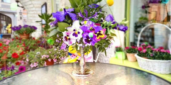 summer flower shop and marketplace  on the street beautiful flower bouquets in vases and planter baskets on  the city in Tallinn old town travel to Estonia