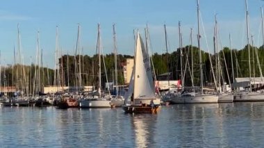  Tallinn, Estonya, Baltık Denizi limanı, deniz suyu, marina ve güneşli gün arka planındaki yamaçların liman yansıması önünde yatlar. 