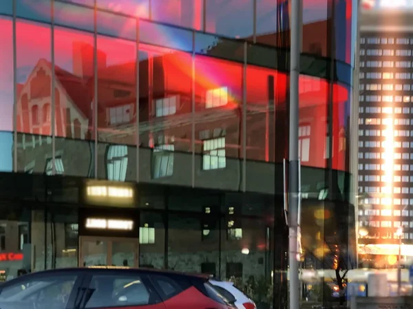 evening red light reflection on windows  modern and vintage house windows in street at sunset  sunlight on vitrines glass urban city architecture