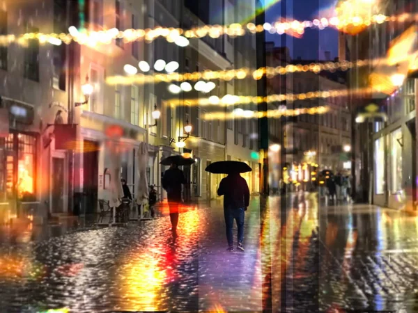 festive rainy city night light  street reflection people with umbrellas  buildings blurred light red yellow bokeh vew from window urban  Tallinn old town medieval  holiday  lifestyle weather forecast season