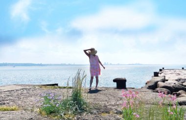 young woman silhouette in window frame on  orange sunset at sea summer evening nature landscape 