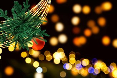 Christmas red ball and green tree branch gold garland on bokeh soft template banner holiday festive winter background