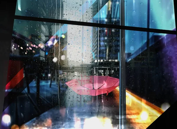 rain in  city street, people silhouette with umbrellas ,modern and vintage building ,Rainy weather season ,Autumn leaves on window,wet drops ,night  blurred light  reflection cold urban  defocus   background