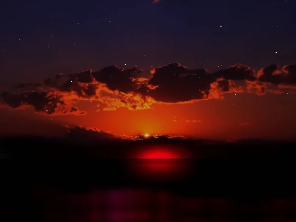 dark starry sky orange late sunset at night sea nature landscape ,dramatic clouds